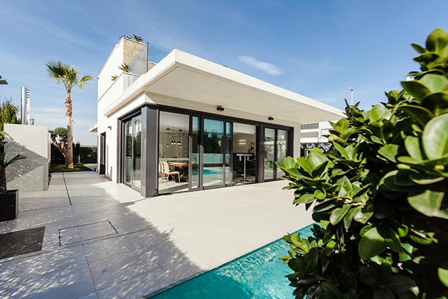 A house with glass doors and a pool