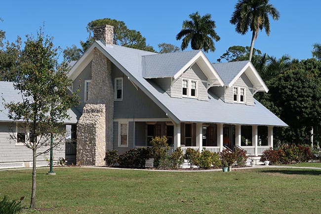 A house with gray roofs and brick chimney