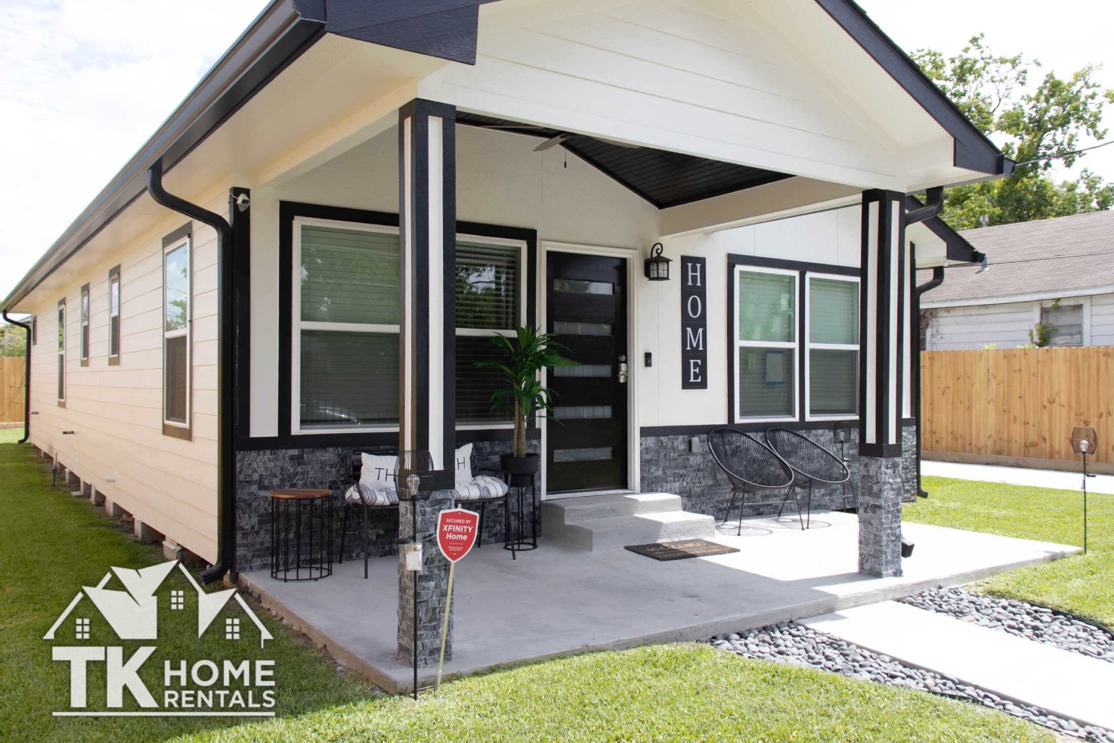 A house with beige paint and dark accent color