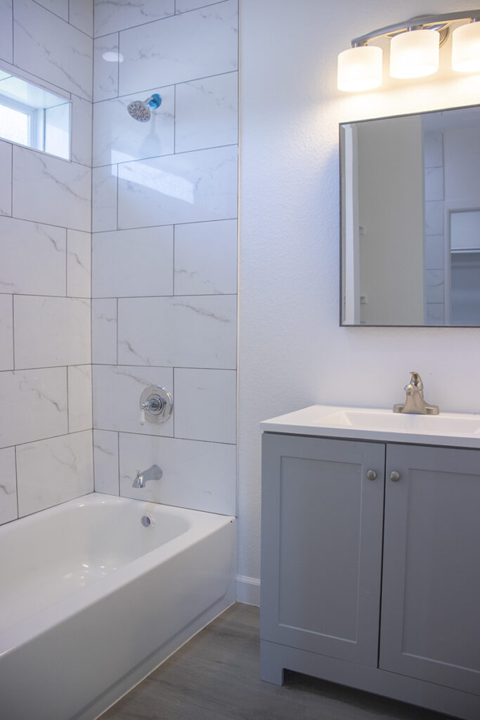 A beautiful white color bathroom with a bathtub